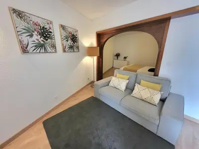 a living room with a couch and a mirror at Vale Formoso Apartment in Porto