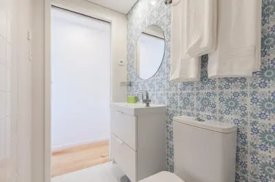 a bathroom with a white toilet and a mirror at Sendme2Portugal: Loureiro in Porto