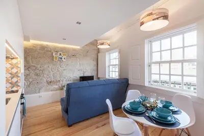 a living room with a blue couch and a table at Sendme2Portugal: Loureiro in Porto