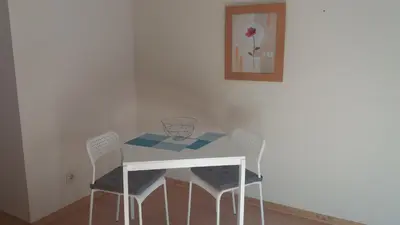 a white table with two chairs and a vase on it at Pachecos in Porto