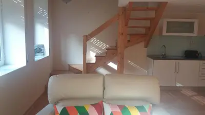 a living room with a white couch and a staircase at Pachecos in Porto