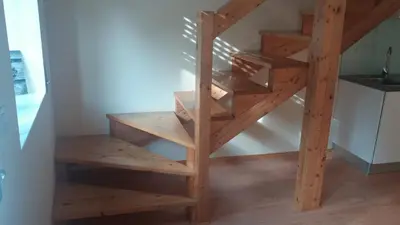 a wooden spiral staircase in a room with wooden floors at Pachecos in Porto