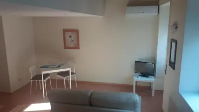 a living room with a couch and a table and a tv at Pachecos in Porto