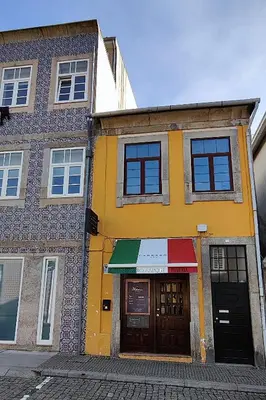 a yellow building with awning on a street at O'Porto Cheers Gaia in Vila Nova de Gaia