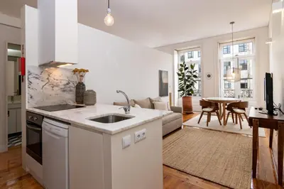 a kitchen and living room with a sink and a couch at Studio Sta in Porto
