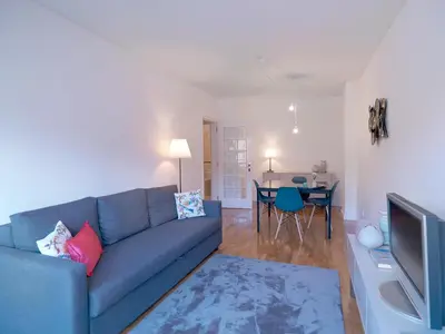 a living room with a blue couch and a table at FLH Porto Comfort Flat in Porto
