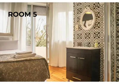 a bedroom with a bed and a mirror on a wall at BCharming House in Porto