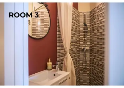 a bathroom with a sink and a shower with a mirror at BCharming House in Porto