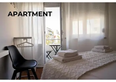 a room with a bed with a chair and a window at BCharming House in Porto