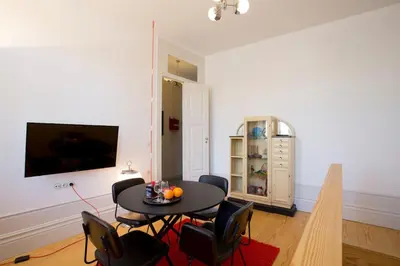 a living room with a black table and chairs at 14º Esquadra — Cais das Pedras Guest House in Porto