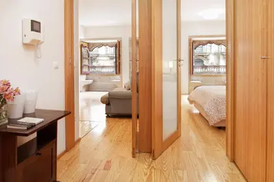 a room with a bedroom with a bed and a mirror at Flowerstreet54 in Porto