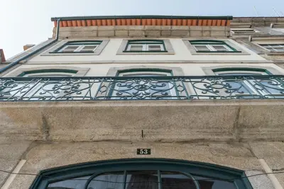 a building with a balcony on top of it at GuestReady - Clérigos Virtudes Apartments in Porto