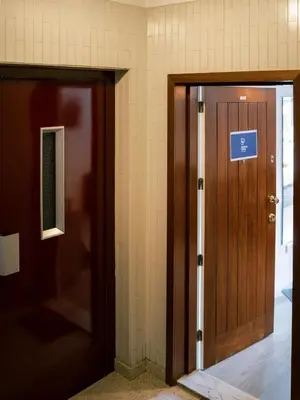 an entrance to a hallway with a wooden door at PortoVivo Quental Apartamento in Porto