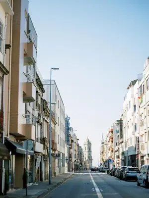an empty street in a city with buildings at PortoVivo Quental Apartamento in Porto