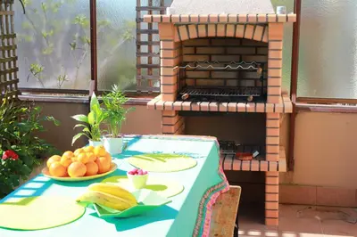 a table with a plate of food and a pizza oven at Cozy Apartment with Terrace, Air Cond, Free Parking, by Porto with Love LDA in Porto