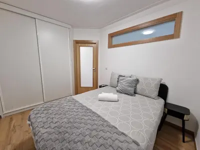 a bedroom with a bed with a gray comforter at Cozy Apartment with Terrace, Air Cond, Free Parking, by Porto with Love LDA in Porto
