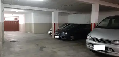 a garage with two cars parked in it at Cozy Apartment with Terrace, Air Cond, Free Parking, by Porto with Love LDA in Porto