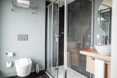 a bathroom with a shower and a toilet and a sink at Stay Hotel Porto Centro Trindade in Porto