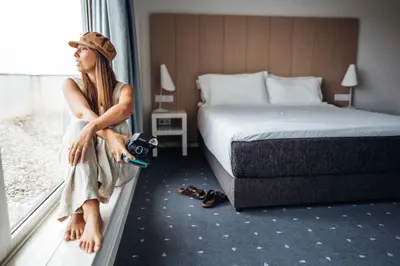 a woman sitting on a window sill holding a camera at Stay Hotel Porto Centro Trindade in Porto