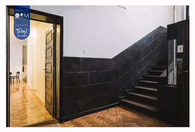 a stairway with a black brick wall next to a door at ORM - Saraiva de Carvalho Apartments in Porto