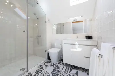 a white bathroom with a shower and a toilet at LovelyStay-Modern Loft City Center in Porto