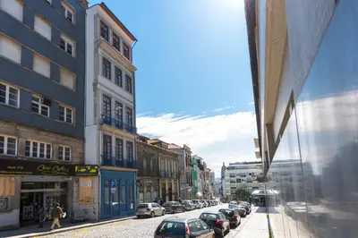 a city street with cars parked on the street at LovelyStay-Modern Loft City Center in Porto