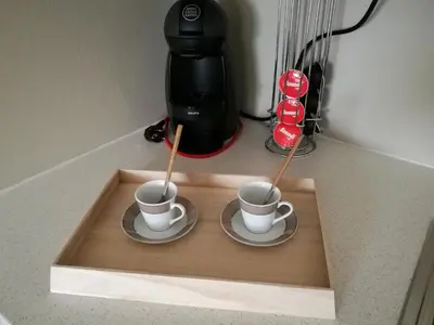 two cups of coffee on a tray on a counter at Pontocom Bolhão Apartment in Porto