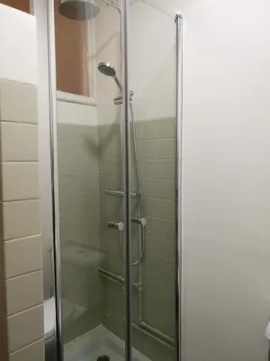 a shower with a glass door in a bathroom at Pontocom Bolhão Apartment in Porto