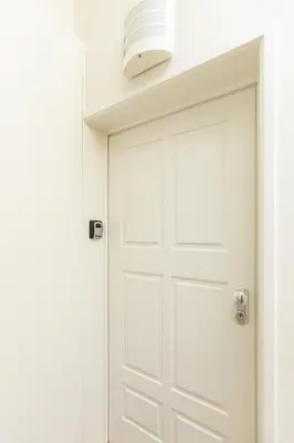 a white door with a light above it at Charming Balcony Apartment in Historic Ribeira - Inside Porto Apartments 