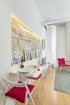 a living room with a white table and chairs at Charming Balcony Apartment in Historic Ribeira - Inside Porto Apartments 