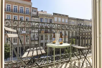 two bottles of beer sitting on a table on a balcony at Charming Balcony Apartment in Historic Ribeira - Inside Porto Apartments 