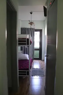 a small bedroom with a bunk bed and a doorway at Mirandesa Garden in Porto