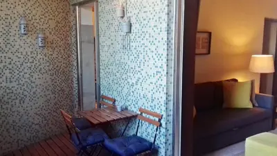 a room with a table and a chair and a couch at Bombarda House & Home in Porto