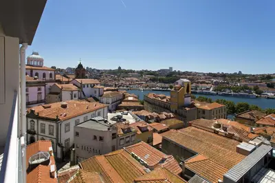 a view of a city with roofs and a river at RVA - Sao Joao Novo Apartments in Porto