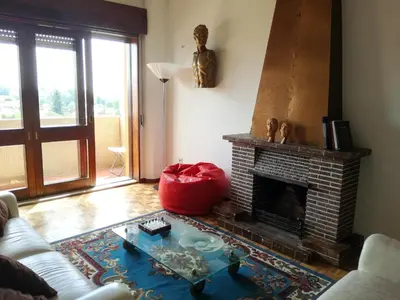 a living room with a couch and a fireplace at A Casa das Margaridas in Porto