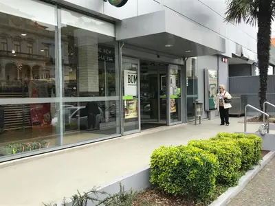 a woman walking outside of a store front at A Casa das Margaridas in Porto