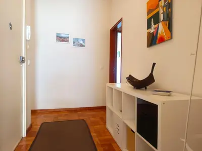 a room with a white cabinet with a black item on it at Combatentes Apartment in Porto