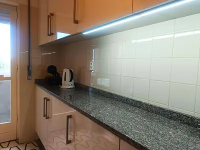a kitchen with white tiled walls and a counter at Combatentes Apartment in Porto