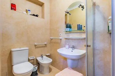 a bathroom with a toilet and a sink and a shower at Riverside City Centre Apartments in Porto