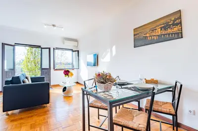 a living room with a table and chairs and a couch at Riverside City Centre Apartments in Porto