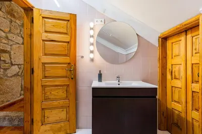 a bathroom with a sink and a mirror at Riverside City Centre Apartments in Porto