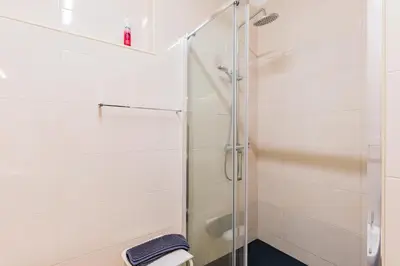 a bathroom with a shower with a glass door at Riverside City Centre Apartments in Porto
