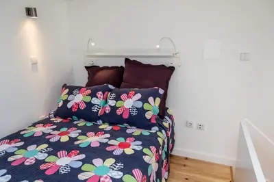 a bedroom with a bed with a floral bedspread at Porto City Center 2 in Porto