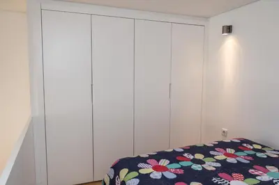 a bedroom with white cabinets and a bed at Porto City Center 2 in Porto