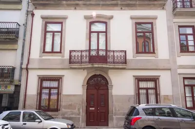 a building with two cars parked in front of it at Porto City Center 2 in Porto