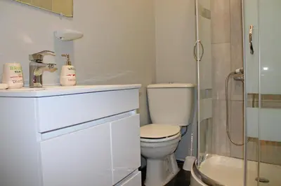 a bathroom with a toilet and a sink and a shower at Trindade Oporto Apartments Group in Porto