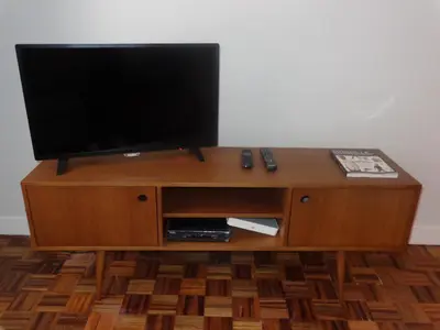 a television on top of a wooden entertainment center at Ribeira Apartment in Porto