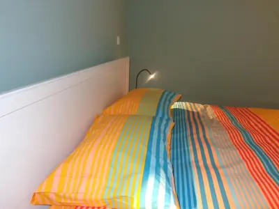 a bed with a colorful comforter in a bedroom at Ribeira Apartment in Porto