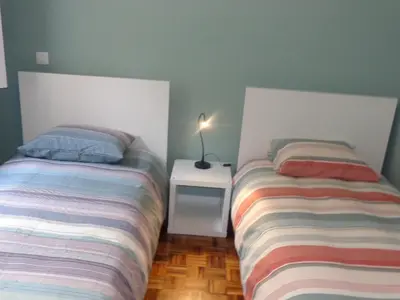 two beds sitting next to each other in a bedroom at Ribeira Apartment in Porto