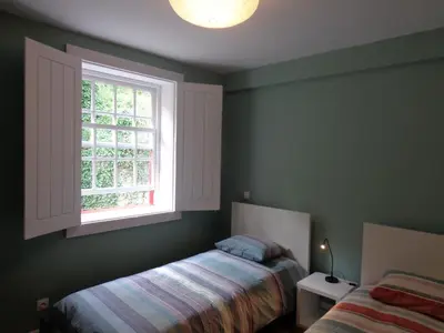 a bedroom with a bed and a window at Ribeira Apartment in Porto
